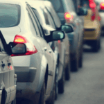Cars banked up on highway – noise mitigated by noise barrier