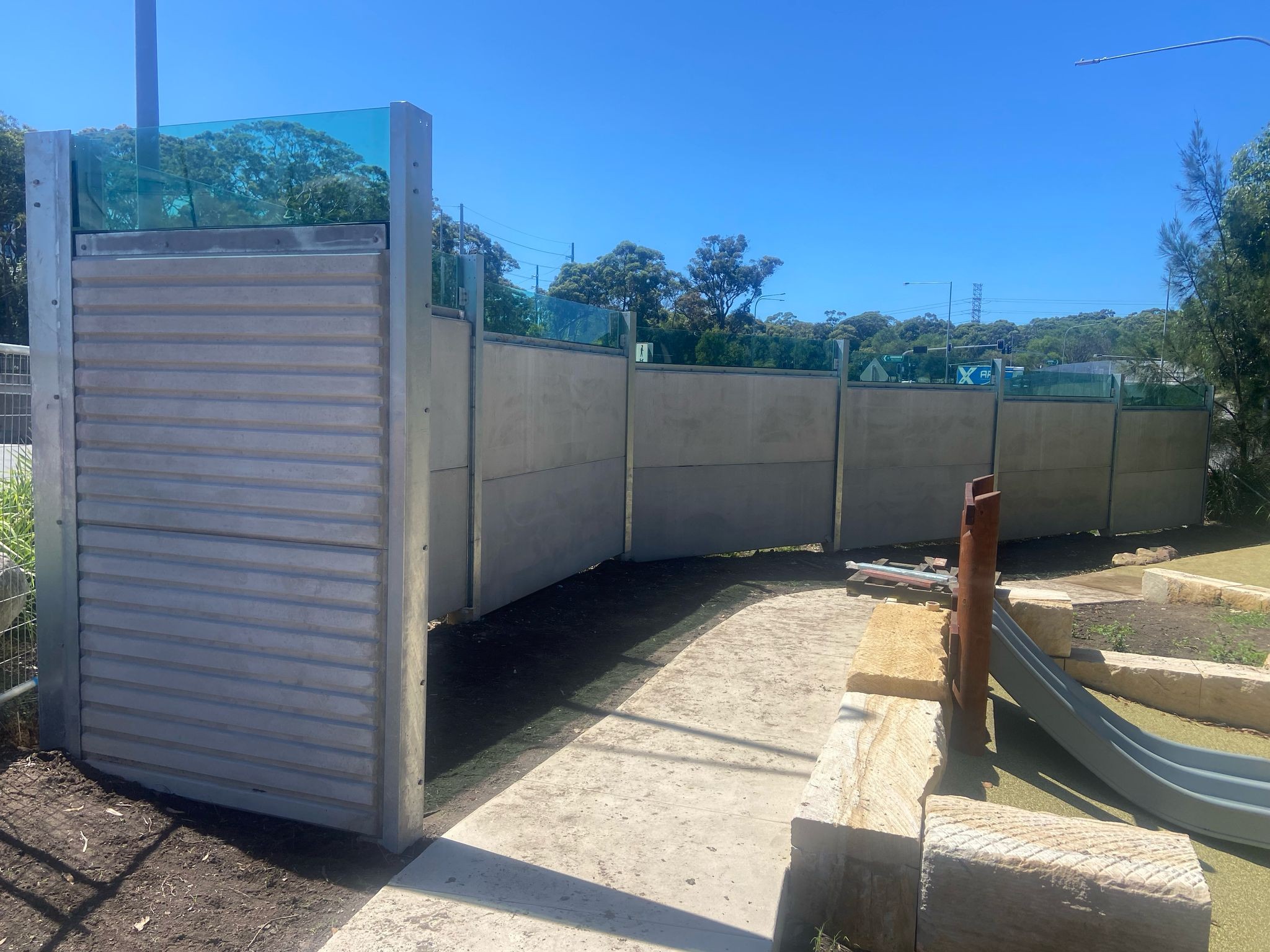 An image of a concrete noise barrier wall designed and constructed by Wallmark Heuron Group to meet Australian compliance.